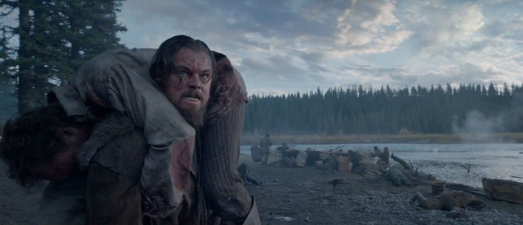 Leonardo DiCaprio carries a man on his back in 'The Revenant